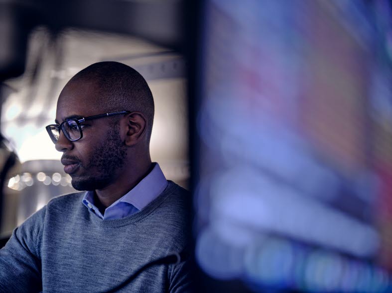 Image of a man looking at computers.