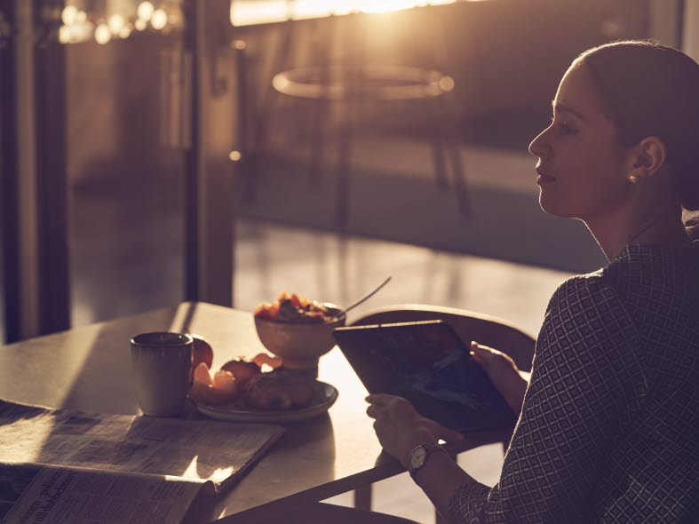 Image of a woman by her table with a pad.