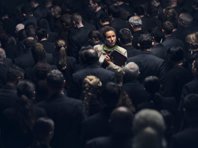 Woman highlighted in a dark crowd of people