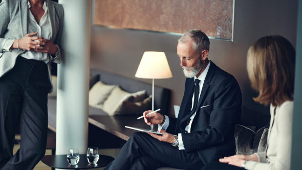 Three people discussing in a coffee corner